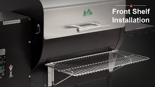 Front shelf installation on a Green Mountain Grill, featuring a stainless steel shelf and the grill's logo.