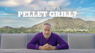 Man sitting at a table outdoors, promoting the benefits of using a pellet grill, with mountains and a scenic backdrop.