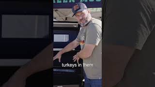 Man demonstrating a Green Mountain Grill pellet grill, highlighting its capacity for cooking multiple turkeys, with a focus on grilling features and functionality.