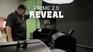 Man unveiling the Green Mountain Grills Prime 2.0 pellet grill, showcasing features and design in a promotional reveal setting.